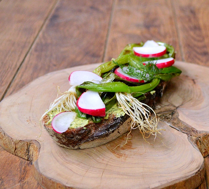 Rye crostini with dill butter, radishes & spring onion