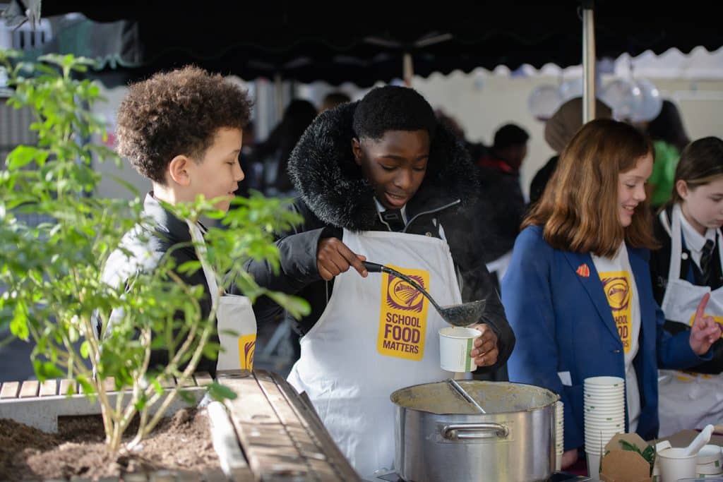 Students selling soup at a Borough Market soup sale