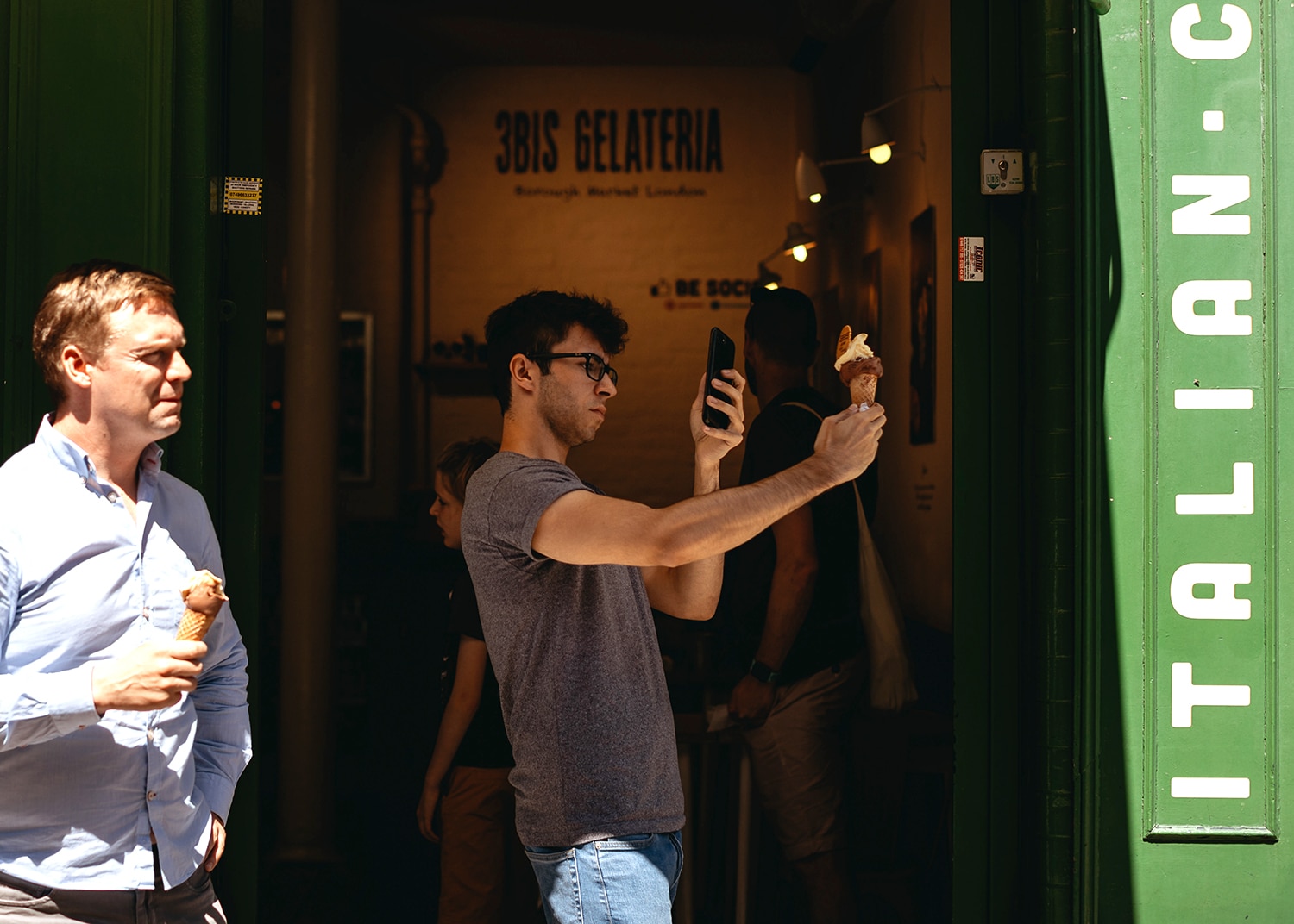 A man takes a photo of an ice cream at Borough Market