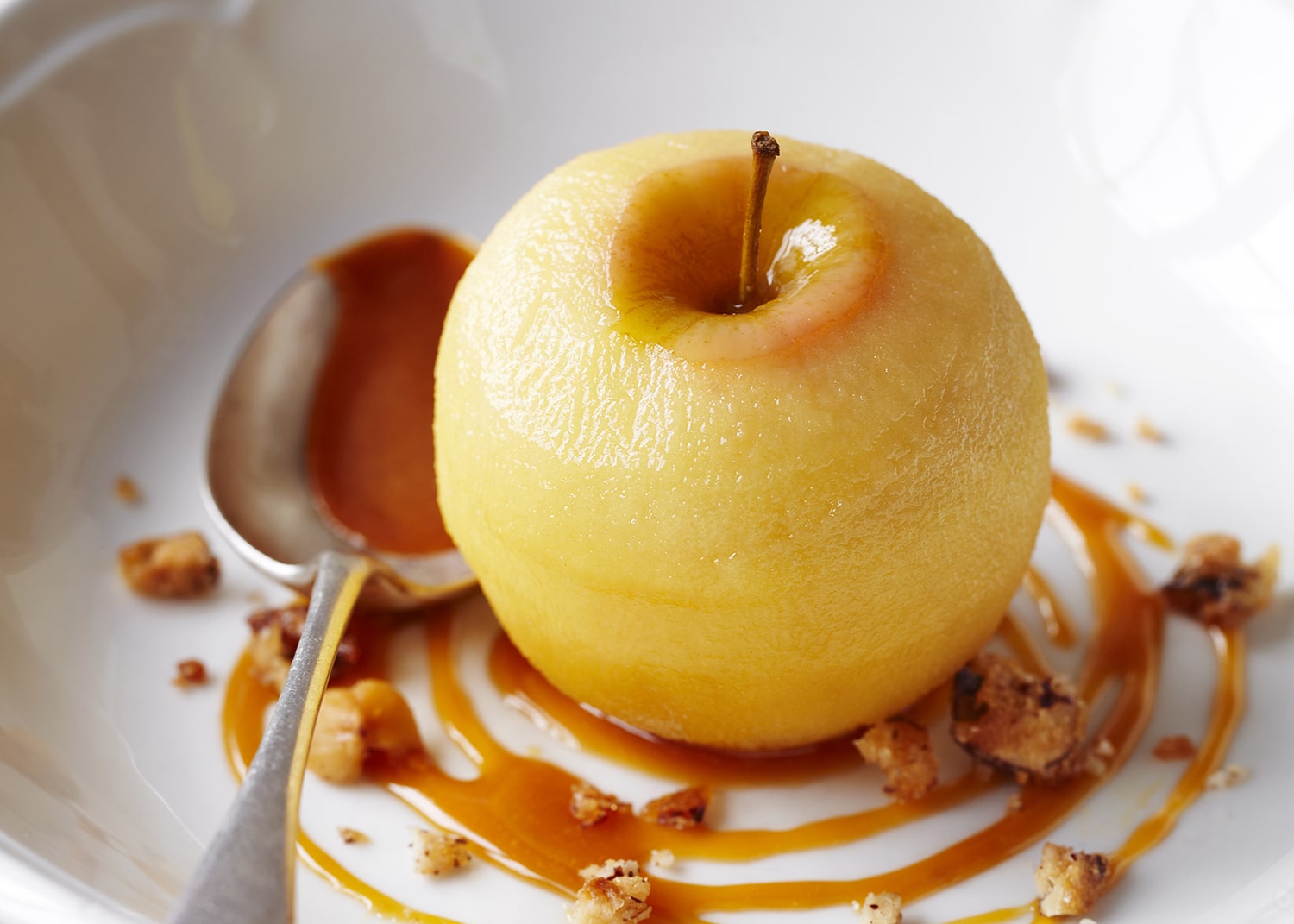 Cider-poached apples with toffee sauce and candied hazelnuts