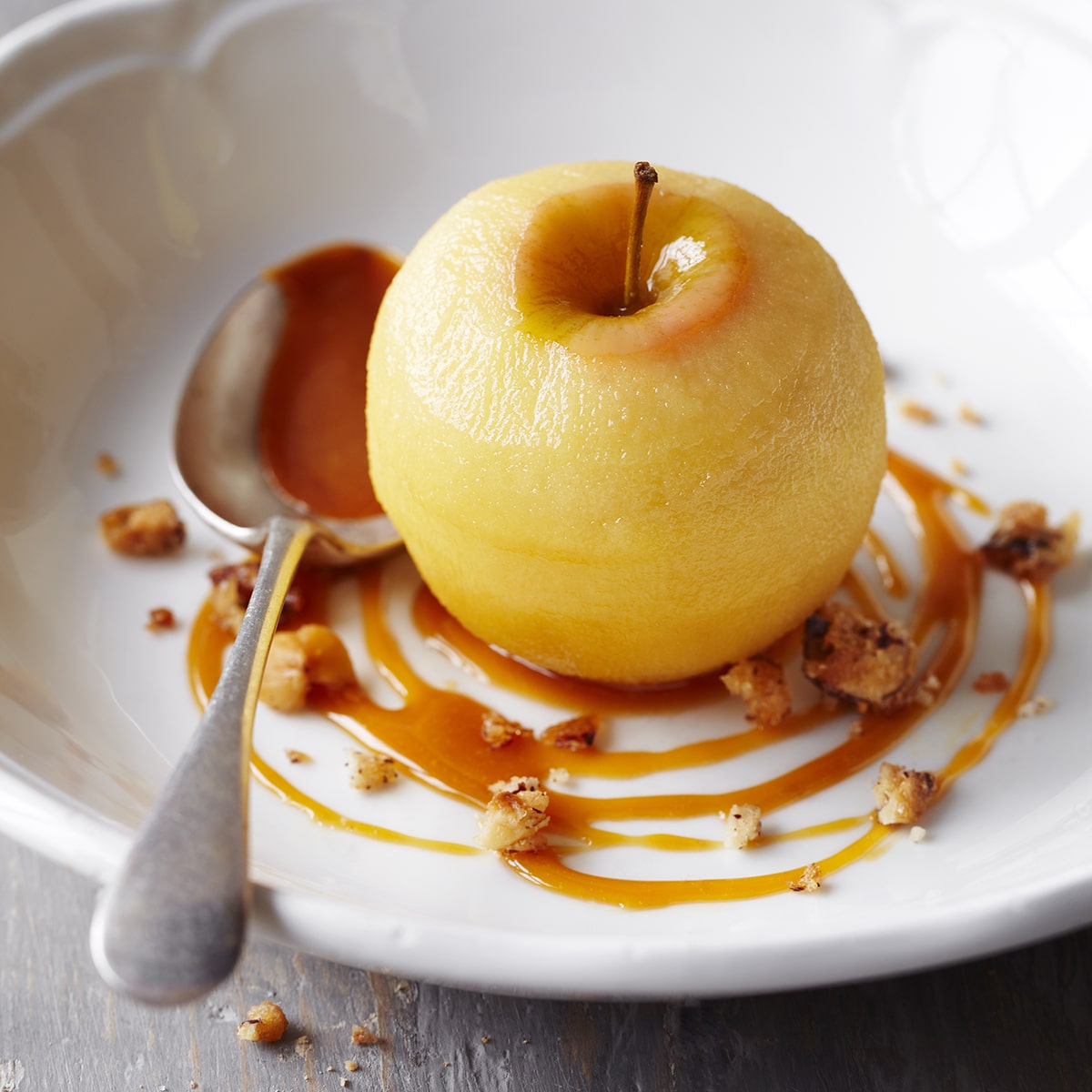Cider-poached apple with toffee sauce & candied hazelnuts